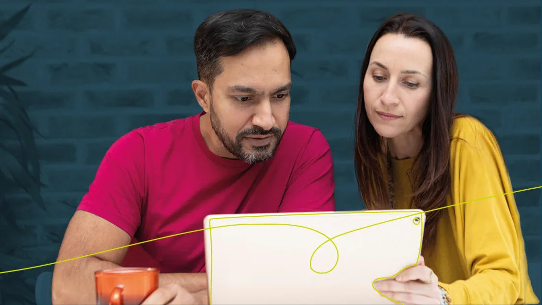 Man and woman looking at a tablet together